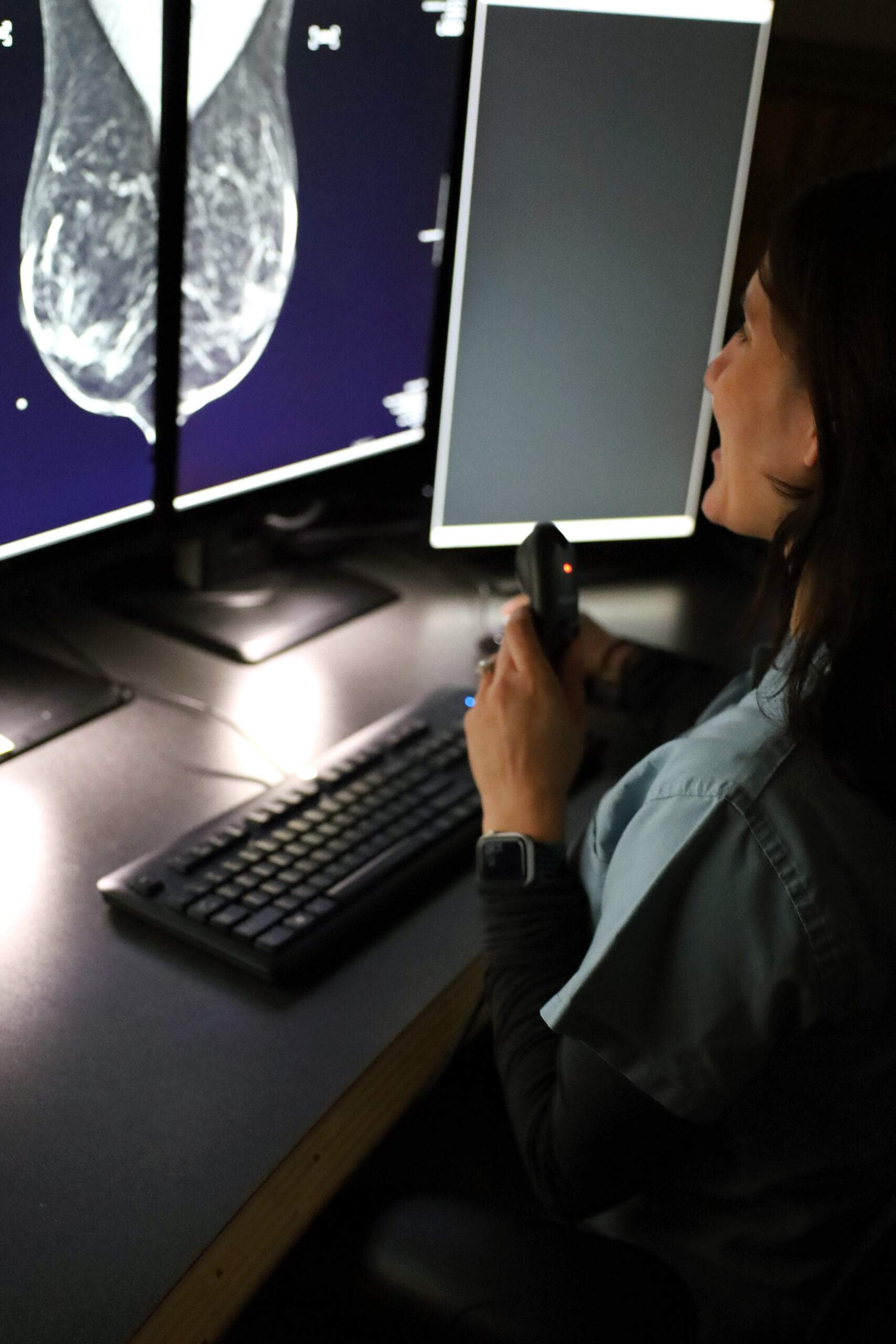 A doctor examining a mammogram readout