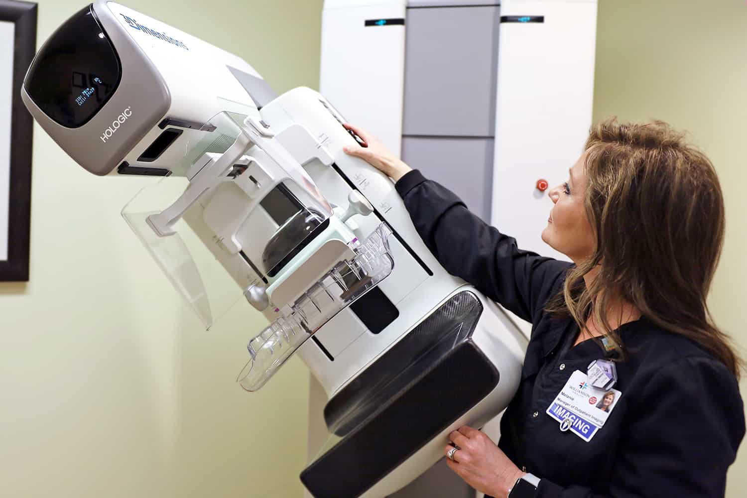 A doctor inspecting the mammogram machine