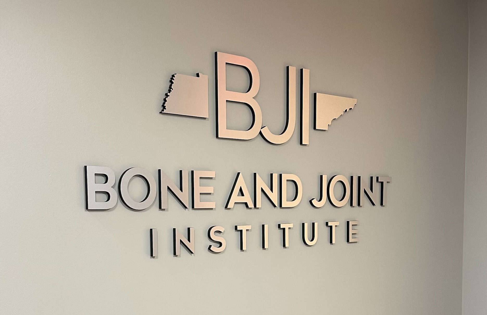 A TN Bone and Joint Institute sign hanging on the wall